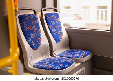 Blue passenger chairs in public bus.  Vacant subway wagon with free seats. Tram transport seats in empty  vehicle
