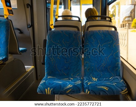 Blue passenger chairs in public bus.  Subway wagon with free seats. Tram transport seats are empty. 