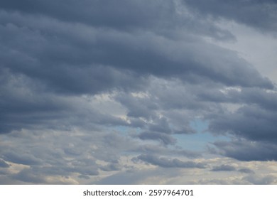 A blue patch of sky peeks out from under the grey clouds