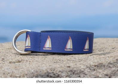 A Blue Patterned Web Belt With Sailing And Boating Patterns On For A Preppy Custom Look. This Belt Is Outdoors, And Made For Stylish Men.