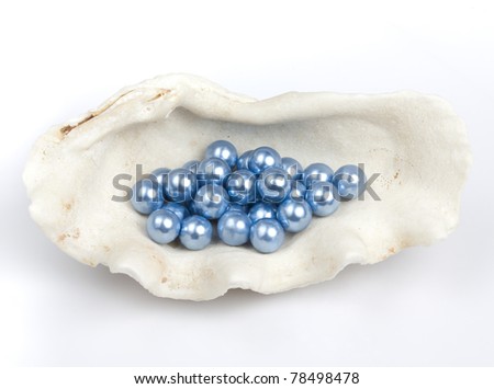Blue pearls in a shell isolated on white background