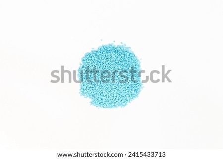 Blue pellet chemical for garden pest slug and snail control on white isolated background.