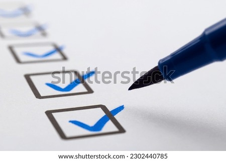 Blue pen marking on checklist sheet