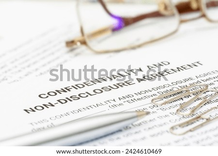 Blue pen on a confidentiality and non-disclosure agreement form. A confidentiality and non-disclosure agreement form safeguards sensitive information, outlining obligations, exceptions, and remedies.