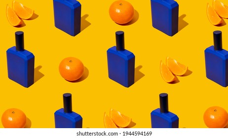 Blue Perfume Bottle With Mandarin Slices On A Orange Background. Fresh Citrus Fruits Flavor Concept. Style Pattern With Shadows. Atypical Colors. Unusual Hues. Bold Colors. Top View.Copy Space.Banner