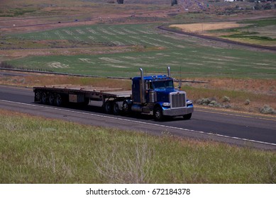 A Blue Peterbilt Semi-truck Pulls An Empty Flatbed Trailer.
June 20th, 2017
Oregon, USA