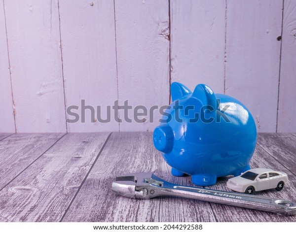 The\
blue piggy bank and car for saving or car concept\
