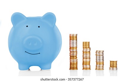 Blue piggy bank with coins isolated on white