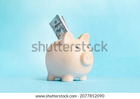 Blue piggy bank money box blue background.