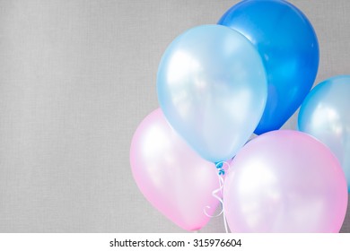 Blue And Pink Balloons On Gray Wall