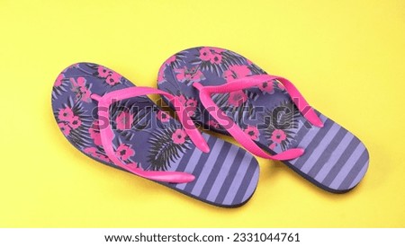 blue and pink flip flops isolated on colour background. Top view