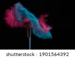 Blue and pink makeup on a powder brush hit in a mixed cloud