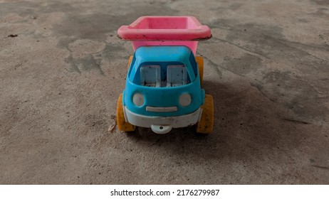 Blue And Pink Toy Truck On The Floor