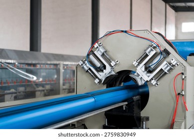 Blue pipe processing equipment on water-resistant production line in industrial factory