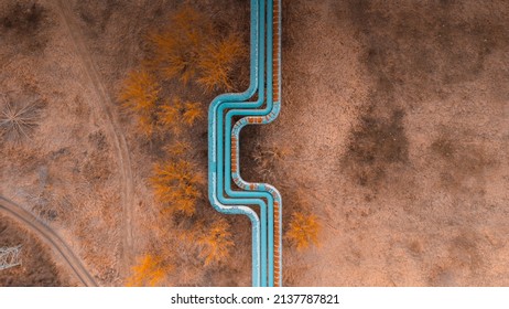 Blue Pipeline Over The Fields. Abstract Aerial View Drone Photo