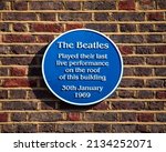 A blue plaque on Savile Row in Mayfair, London, marking the location and commemorating the final live performance by The Beatles, which took place on the roof of the building on 30th January 1969.