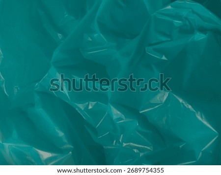 Blue plastic bag texture represents ocean or environment for background.  
