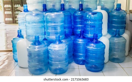 Blue plastic bottles or blue gallons of drinking water are stacked in the drinking water factory to cycle water factory  business concept