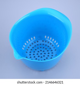 blue plastic colander on a white isolated background