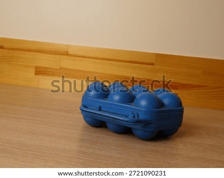 Blue plastic egg storage container placed on kitchen countertop