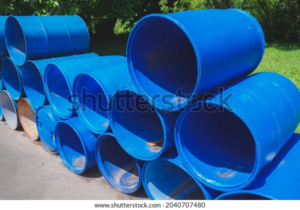 Blue plastic gallon drums barrel overlie together
at a recycling plant