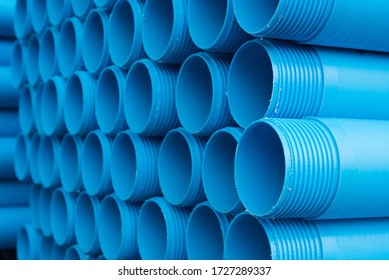 Blue Plastic Pipes Laid On Special Metal Shelving. Production And Marketing Of Plastic Pipes