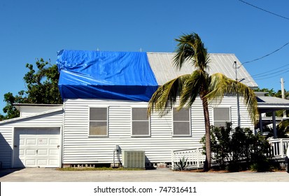 Blue Plastic Tarpaulin Temporarily Covers Roof Damage Caused By Hurricane Irma In Key West,  Florida.