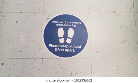 Blue Please Stay Six Feet Apart Sign On White Tiles