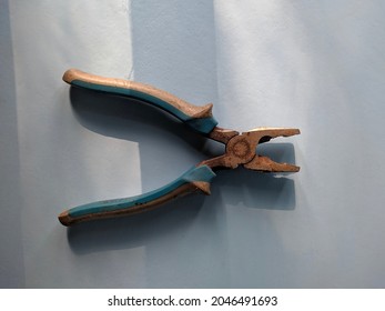 Blue Pliers On A Light Blue Background