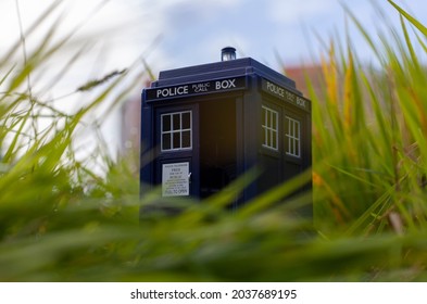 Blue police box as Tardis from Doctor Who in green grass. Time machine. Geek object. 