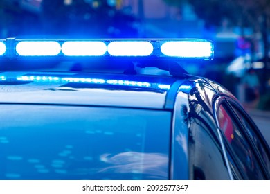 Blue Police Lights On Top Of A Patrol Car During The Day