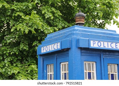 A blue police telephone box on the street in Glasgow, Scotland, United Kingdom, often associated with the science fiction television program Doctor Who