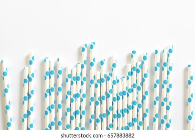 Blue Polkadot Paper Straws On White Background.