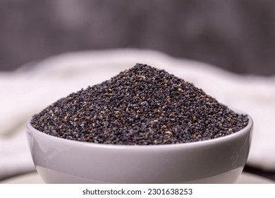 Blue poppy seeds. Spices concept. Blue poppy seeds on dark background. Close up