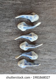 Blue porcelain  pottery catfish on the textured floor as background. Decoration. Collection and hobby. Zigzag. Malaysia