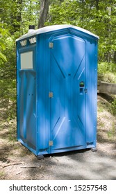 A Blue Porta Potty Located On The Hiking Trail