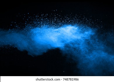 Blue Powder Explosion On Black Background. Colored Cloud. Colorful Dust Explode. Paint Holi.