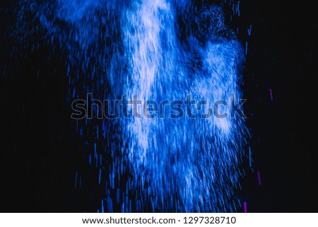 Blue powder explosion on black background. Colored cloud. Colorful dust explode. Paint Holi.

