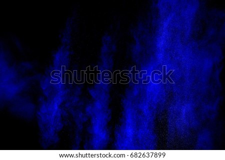 blue powder explosion on black background