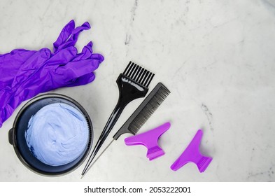 Blue Powder Hair Dye Bleaching Tools With Gloves, Comb And Brush On Marbled Background