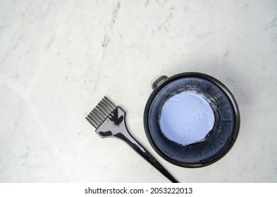 Blue powder hair dye bleaching tools with gloves, comb and brush on marbled background - Shutterstock ID 2053222013