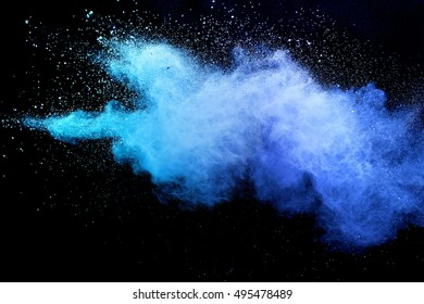 Blue Powder/particles Fly After Being Exploded Against Black Background