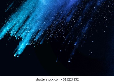 Blue Powder/particles Fly After Being Exploded Against Black Background