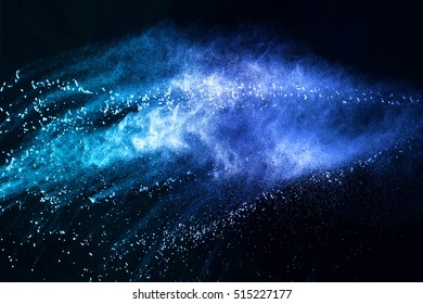 Blue Powder/particles Fly After Being Exploded Against Black Background