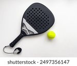 blue professional paddle tennis racket with yellow ball on white background. copy space for text