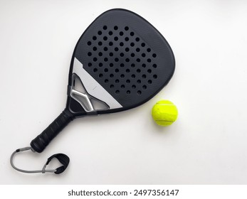 blue professional paddle tennis racket with yellow ball on white background. copy space for text - Powered by Shutterstock