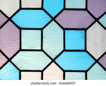 Blue and purple geometric pattern stained glass window abstract background