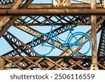 blue push bike hanging from bridge in Winnipeg