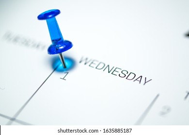 Blue push pin on the 1st  date of the calendar Wednesday - 1st of April Wednesday - April fools day 2020 - Powered by Shutterstock