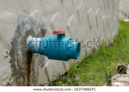 Blue PVC pipe installed for changing water in the hotel's swimming pool.